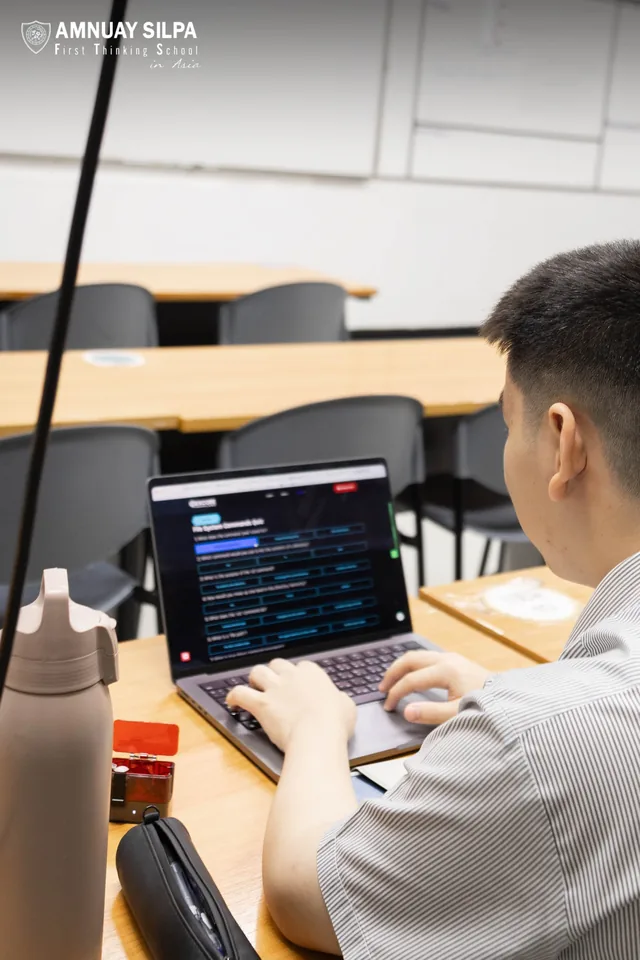 Student working on laptop w/ hexcore arena game branding visible